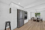 This modern kitchen features sleek stainless steel appliances, including a French door refrigerator and built-in oven and microwave.