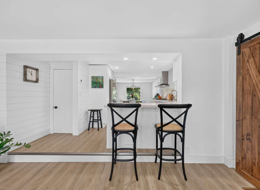 Step into this beautifully renovated home featuring a modern kitchen with a breakfast bar, perfect for casual dining.