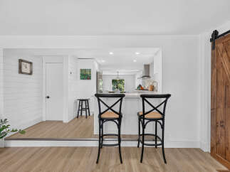 Step into this beautifully renovated home featuring a modern kitchen with a breakfast bar, perfect for casual dining.