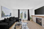 Step into this inviting living room featuring a spacious black sectional sofa perfect for relaxation and entertaining.