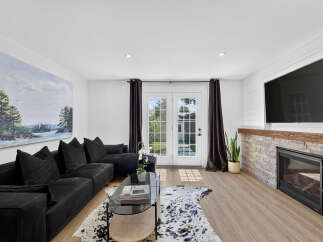 Step into this inviting living room featuring a spacious black sectional sofa perfect for relaxation and entertaining.