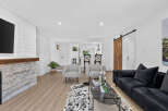 Experience modern living in this beautifully renovated home featuring a stunning stone fireplace and shiplap accent walls.