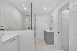 Experience modern luxury in this stunning bathroom featuring a spacious glass-enclosed shower with a rainfall showerhead.