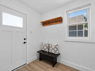 Step into this inviting entryway, featuring a sleek white door with a modern window panel.
