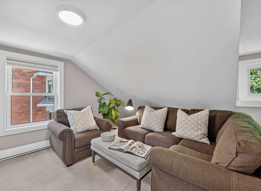 Cozy living room featuring a comfortable brown sofa and armchair, perfect for relaxation.