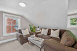 Cozy living room featuring a comfortable brown sofa and armchair, perfect for relaxation.