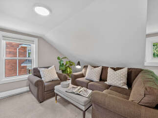 Cozy living room featuring a comfortable brown sofa and armchair, perfect for relaxation.