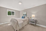 This cozy bedroom features a comfortable bed with crisp white linens and a decorative blue accent pillow.