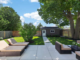 Enjoy outdoor living in this spacious backyard featuring a modern patio area perfect for entertaining.