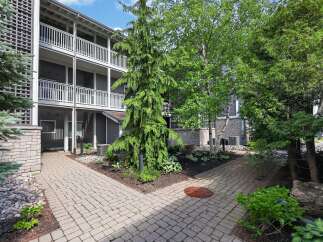 Discover charming outdoor living spaces with this multi-level building featuring private balconies and lush landscaping.