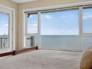 Wake up to breathtaking ocean views from this stunning bedroom.