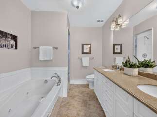 Experience luxury in this stunning bathroom featuring a spacious jacuzzi tub perfect for relaxation.