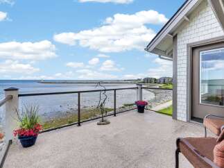 Enjoy breathtaking waterfront views from this stunning balcony, perfect for relaxing or entertaining.