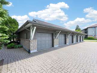 Discover this charming property featuring a multi-car garage with attractive stone accents and durable paver driveway.