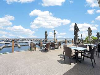 Enjoy breathtaking waterfront views from this stunning patio dining area, perfect for al fresco meals.