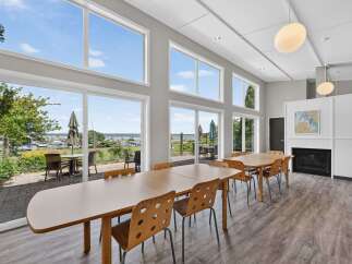 Experience breathtaking waterfront views from this spacious dining area, featuring expansive windows that flood the space with natural light.