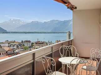 Enjoy breathtaking panoramic views of the lake and mountains from this charming balcony.