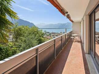 Enjoy breathtaking panoramic views of the lake and mountains from this stunning balcony.