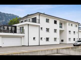 Discover modern living in this stunning white apartment building, featuring a spacious rooftop terrace with panoramic mountain views and a convenient private garage.
