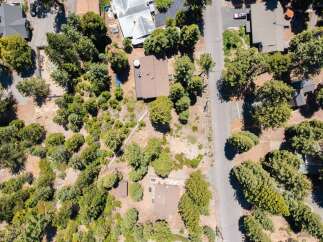 Discover this charming property nestled amongst mature trees, offering a private and serene setting.
