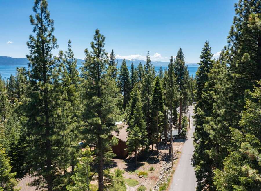 Nestled amidst towering pine trees, this property offers a serene escape with stunning lake views.
