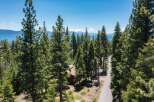 Nestled amidst towering pine trees, this property offers a serene escape with stunning lake views.
