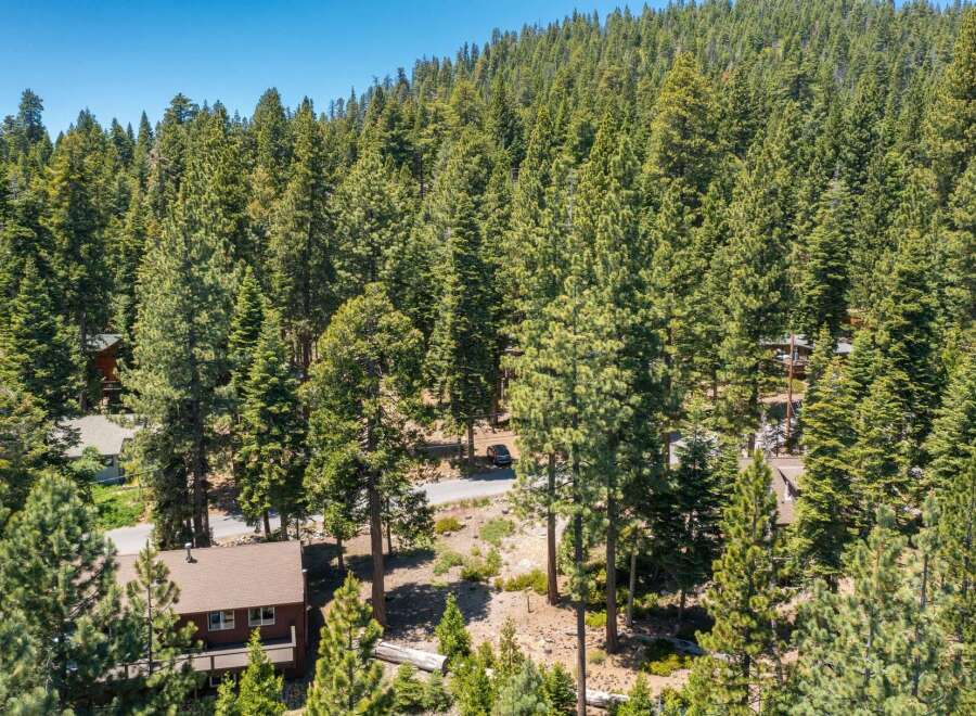 Nestled amidst a dense forest of mature pine trees, this property offers a serene and private mountain retreat.