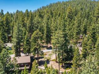 Nestled amidst a dense forest of mature pine trees, this property offers a serene and private mountain retreat.