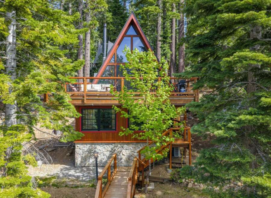 Nestled amidst towering pine trees, this stunning A-frame cabin offers a unique architectural design and a serene mountain escape.
