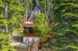 Nestled amidst towering pine trees, this stunning A-frame cabin offers a unique architectural design and a serene mountain escape.