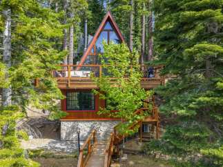 Nestled amidst towering pine trees, this stunning A-frame cabin offers a unique architectural design and a serene mountain escape.