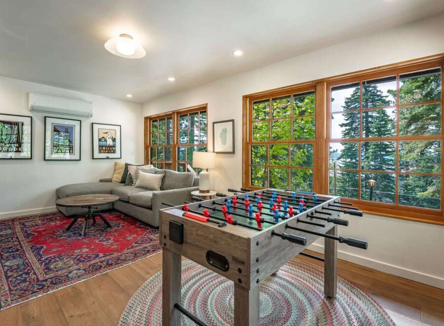 Enjoy endless entertainment in this spacious living area, featuring a fun foosball table perfect for game nights.