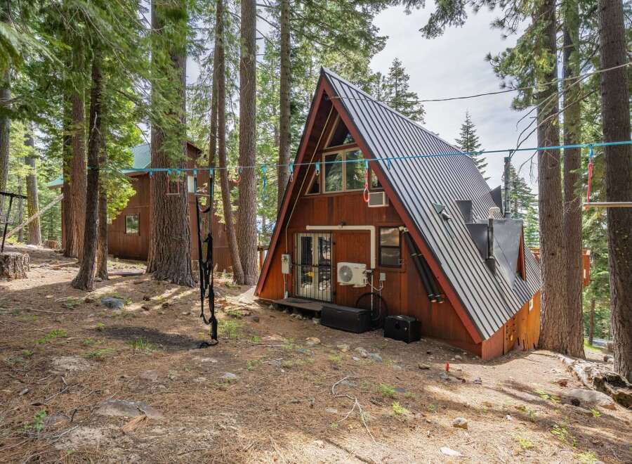 Experience the unique charm of this A-frame cabin nestled amongst tall pine trees.