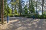 Enjoy outdoor recreation with this beautiful sand volleyball court, nestled among tall pine trees.