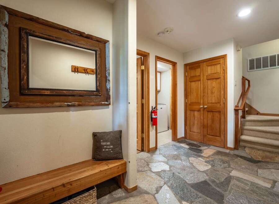 Step into this inviting entryway featuring rustic charm and practical amenities.