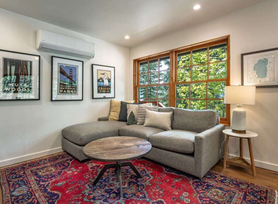 This inviting living space features a comfortable sectional sofa complemented by a rustic wooden coffee table, perfect for relaxing or entertaining.