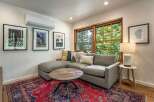 This inviting living space features a comfortable sectional sofa complemented by a rustic wooden coffee table, perfect for relaxing or entertaining.