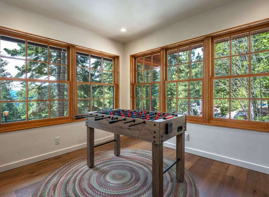 Experience ultimate relaxation and fun in this inviting game room, featuring a rustic foosball table perfect for friendly competition.