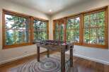 Experience ultimate relaxation and fun in this inviting game room, featuring a rustic foosball table perfect for friendly competition.