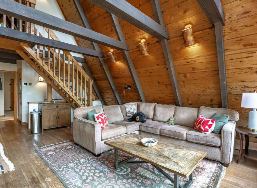 Experience rustic charm in this cozy living room, featuring a plush sectional sofa perfect for relaxation.