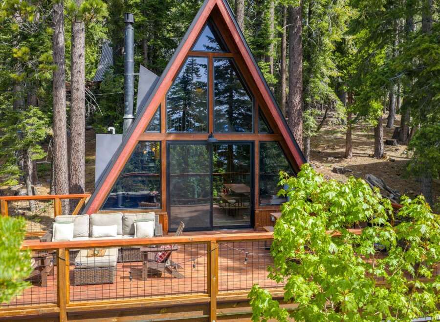 Experience the ultimate mountain retreat in this stunning A-frame cabin nestled amidst towering pine trees.