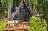 Experience the ultimate mountain retreat in this stunning A-frame cabin nestled amidst towering pine trees.