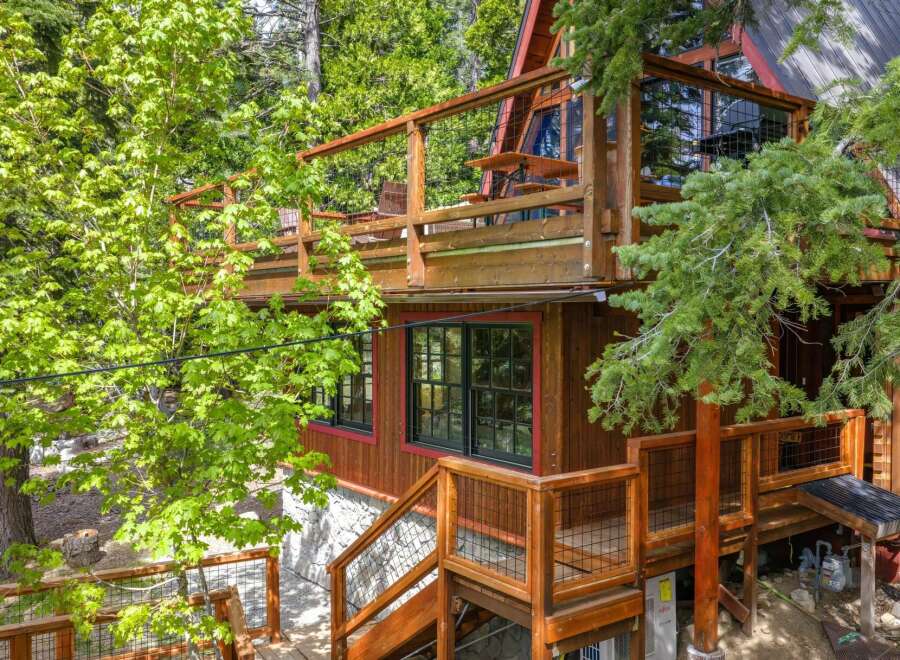 Experience the charm of this A-frame cabin nestled amidst lush greenery.