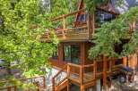 Experience the charm of this A-frame cabin nestled amidst lush greenery.