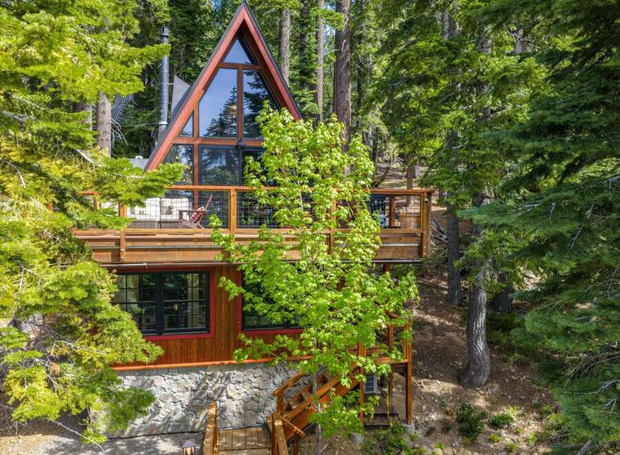 Experience mountain living in this stunning A-frame cabin nestled amongst tall pine trees.