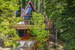 Experience mountain living in this stunning A-frame cabin nestled amongst tall pine trees.
