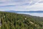 Discover breathtaking lake and mountain views from this stunning property nestled amongst towering pine trees.