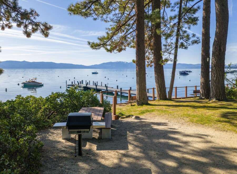 Enjoy lakeside living with this stunning property featuring a private dock and barbecue area.