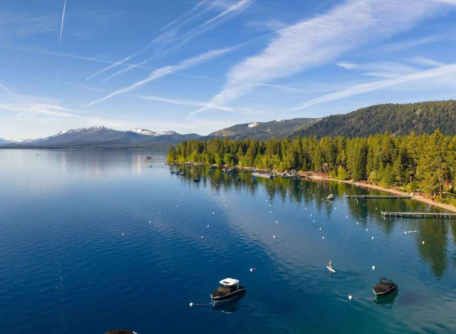 Experience luxury lakeside living with this stunning property featuring a private beach and multiple docks.