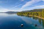 Experience luxury lakeside living with this stunning property featuring a private beach and multiple docks.